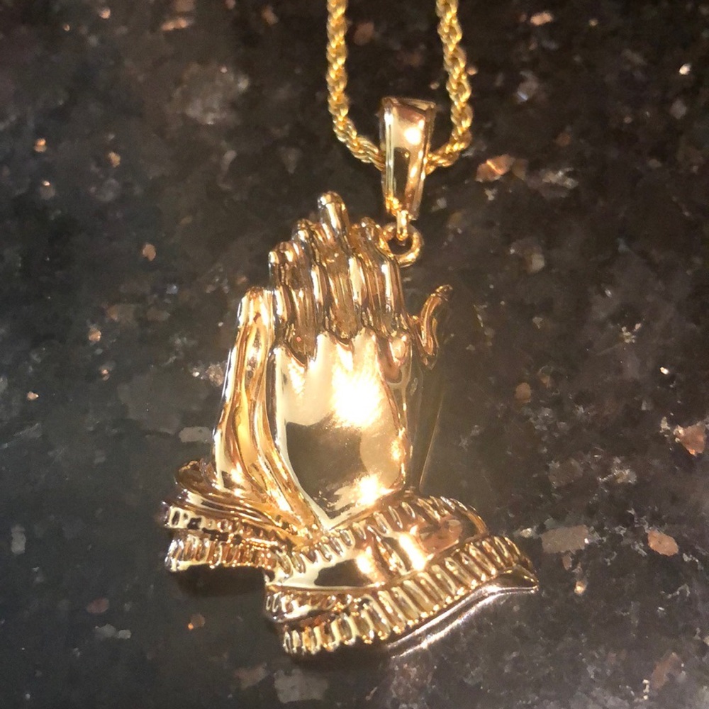 Necklace with praying hands charm